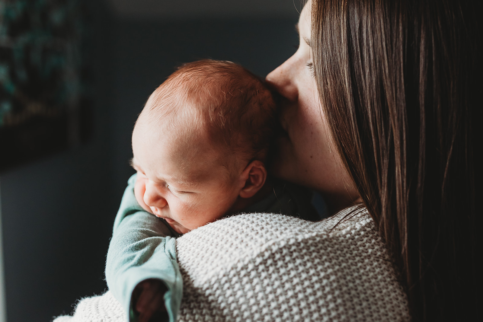 A newborn baby sleeps on mom's shoulder thanks to Genesis Midwifery